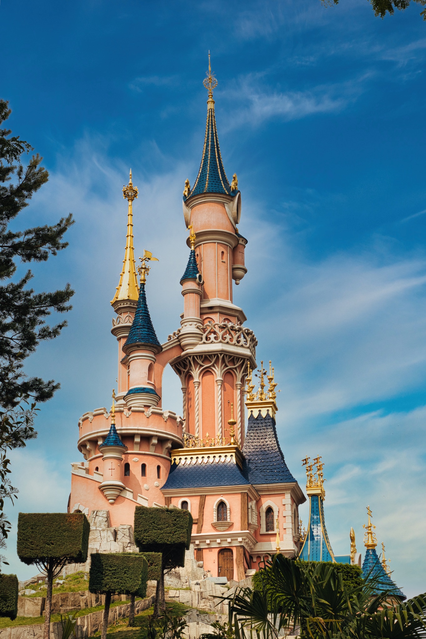Pink Castle with Blue Roofs and Clear Sky at Disneyland Paris, France.