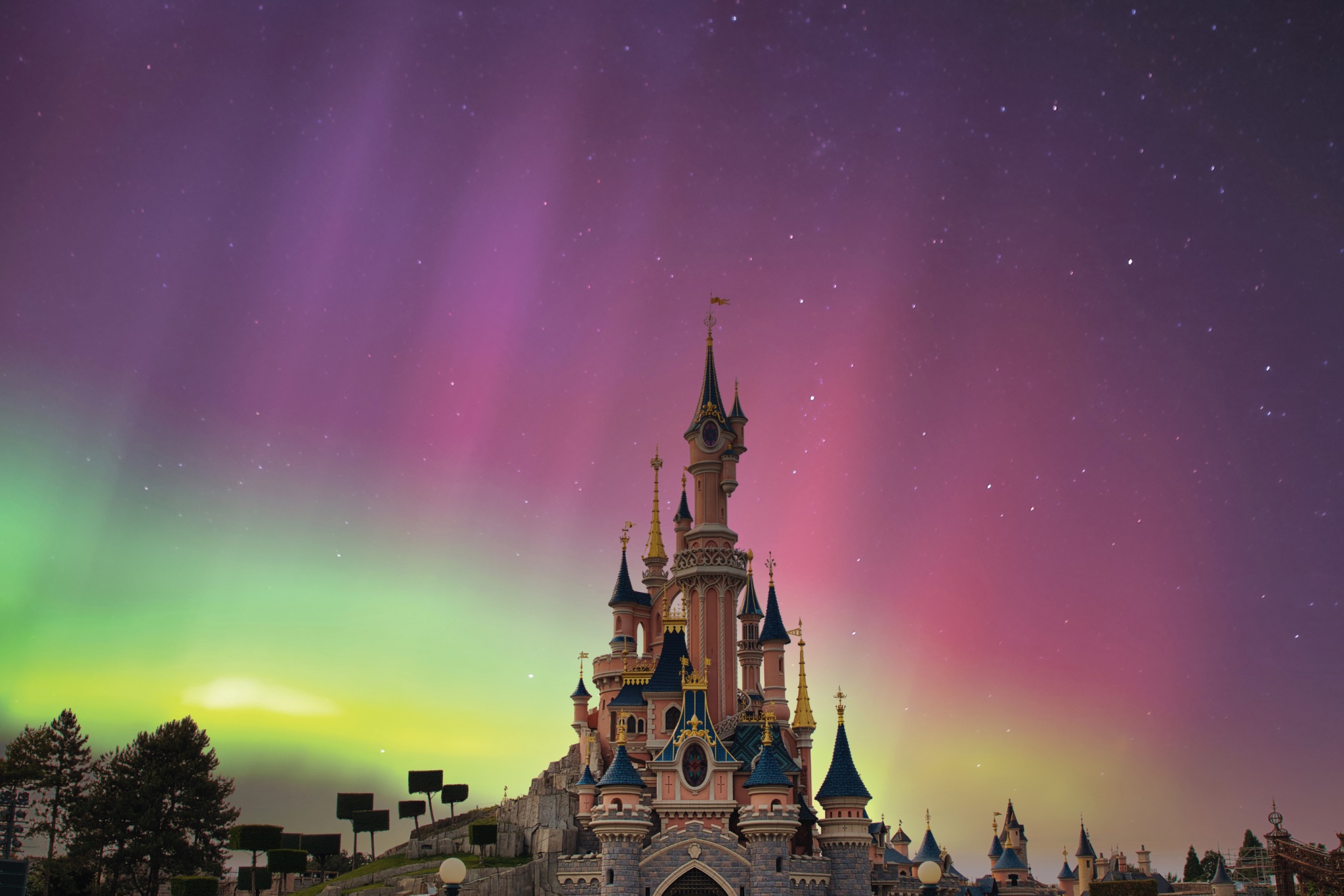 Sleeping Beauty Castle with Aurora Borealis at Disneyland Paris, France.