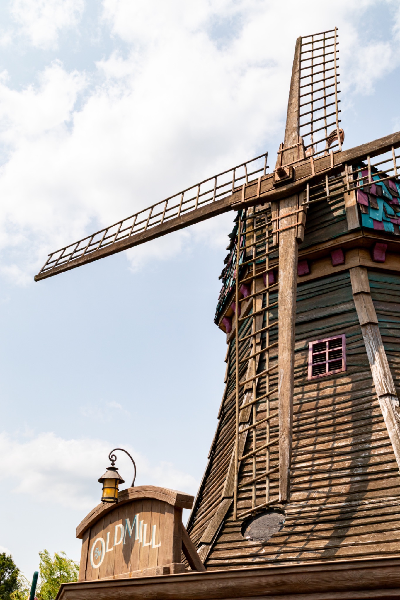 Wooden Windmill Structure with Rotating Blades and Signage at Disneyland Paris.