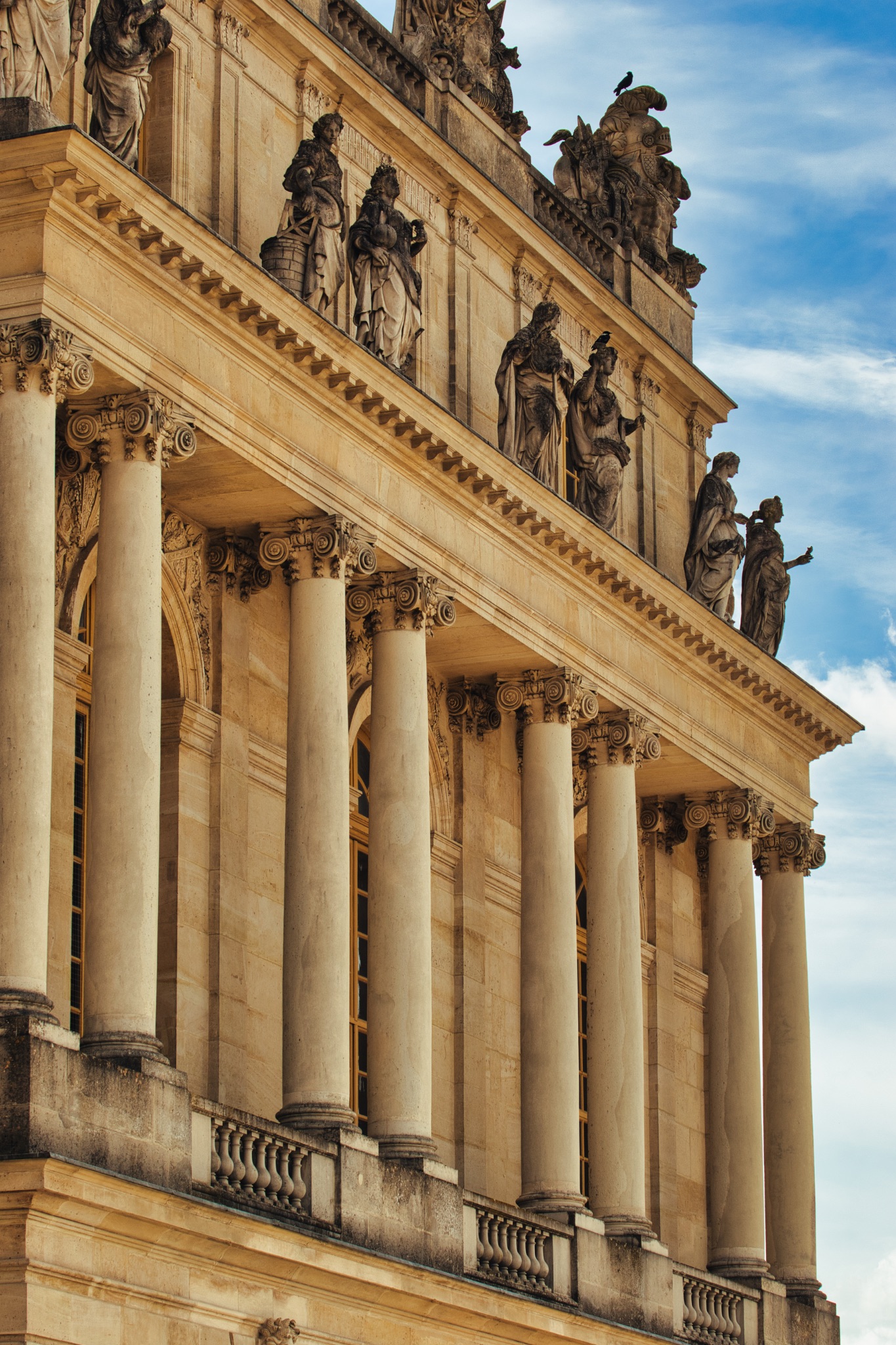 Building Facade with Columns and Statues at Versailles Gardens, Paris.